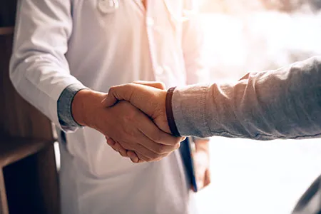 dr shaking a persons hand