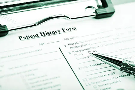 patient history form on a clipboard